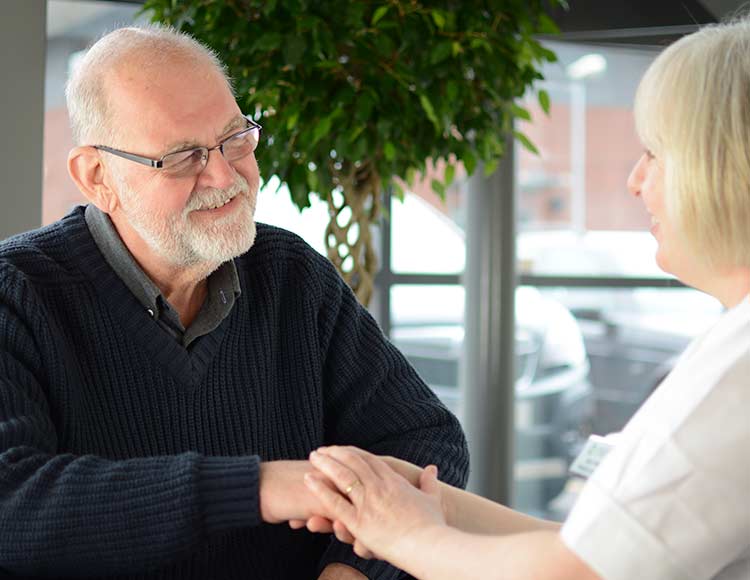 Nurse holding patient's hand